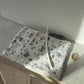 Pochette upcyclée matelassée blanche à fleurs bleues
