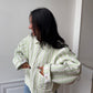 Veste upcyclée matelassée vert clair et motifs